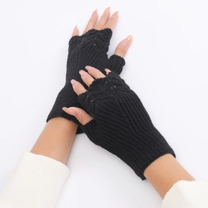 Detail of black knitted fingerless gloves showing a stylish fish scale texture for women