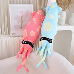Pink and blue squid plush pillows resting on a cozy cream fleece sofa in home setting
