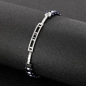 Detail of blue and silver stainless steel motorcycle chain bracelet with industrial link