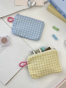 Blue and yellow checkered canvas pouches with pink handles for makeup and small essentials