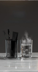 Detail of two dark gray translucent mouthwash cups and matching tray with steam effect