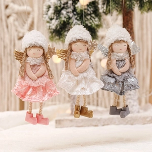Three plush Christmas angel ornaments with lace wings in pink white and grey hanging on tree