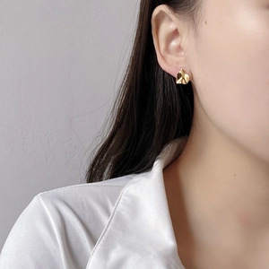 Detail view of French retro irregular S925 silver stud earrings in gold finish on model