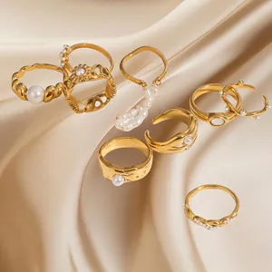 Golden pearl ring set with vintage patterns on elegant champagne silk background