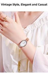 Close-up of mother-of-pearl oval watch with rose gold mesh strap on female model