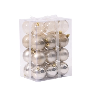 Set of champagne and white Christmas tree ornaments in a transparent gift box packaging