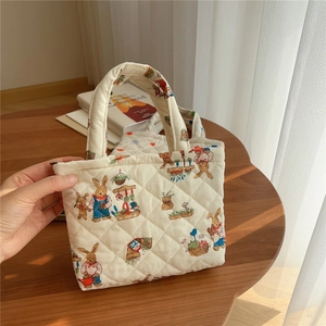 Detailed view of quilted cotton mobile phone bag with cute rabbit gardening patterns