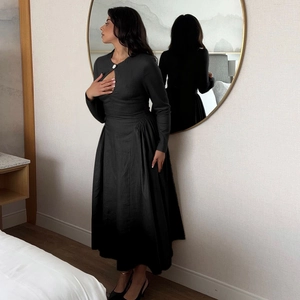 Elegant black long sleeve slim fit dress with waist pleats and neckline cutout detail