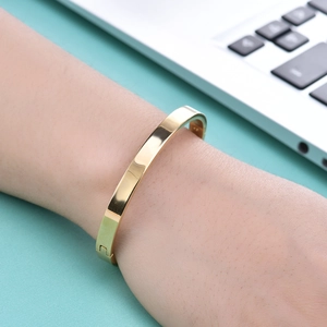 Modern minimalist 6mm polished gold stainless steel bangle with a secure snap closure