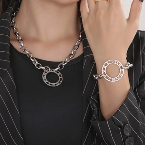 Close-up of silver titanium steel chunky chain necklace and bracelet with Roman numerals