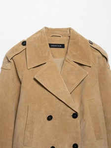 Detail of brown suede jacket showing double-breasted buttons and classic epaulets