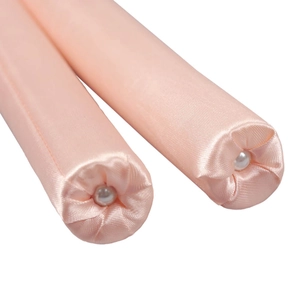 Pink satin heatless hair curler rollers with pearl detail end shown on white background