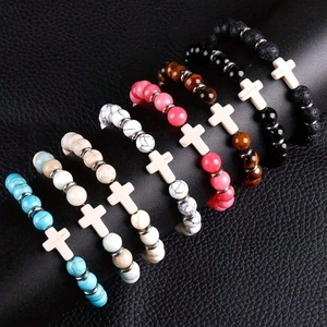 Multiple cross pendant beaded bracelets in lava stone, turquoise, and tiger eye beads
