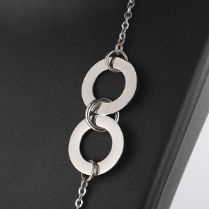 Macro detail of interlocking silver circles on a titanium steel necklace chain