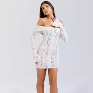 Close-up of intricate white floral lace texture and off-shoulder tie detail on mini dress