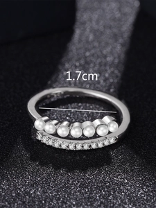 Detail view of adjustable silver ring with pearls and zircon showing 1.7cm inner diameter
