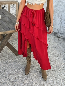 Detail of red tiered ruffle midi skirt with tie-waist in a bohemian style