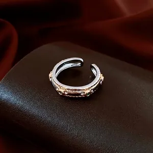 Vintage oval engraved open ring with green stones and gold-silver two-tone finish