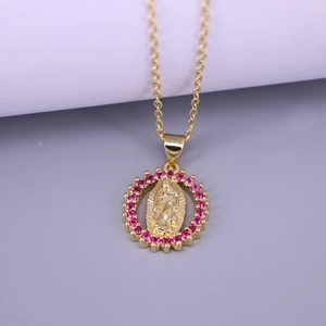 Macro detail of Virgin Mary oval pendant with purple gemstones on golden chain