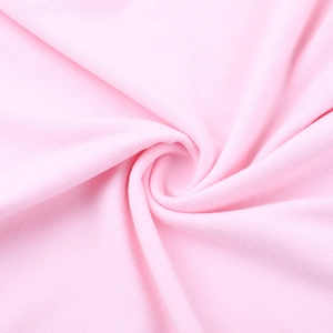 Gros plan du tissu rose de la combinaison montrant sa texture douce et élastique