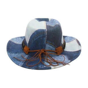 Detail of vintage denim patchwork cowboy hat with leather accents and woven band