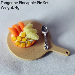 Miniature orange and pineapple pie model with wooden tray and silver spoon for dollhouse