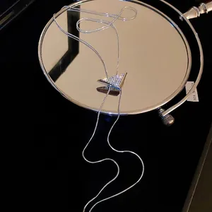 Elegant silver bolo tie necklace with a sparkling diamond-encrusted triangular pendant