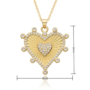 Close-up of gold plated hollow heart necklace with zircon inlay and 30mm size markers