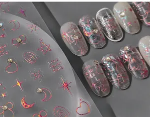 Macro detail of laser red 3D relief nail stickers with stars, moons and bows