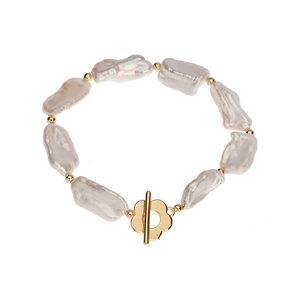 Baroque irregular freshwater pearl bracelet with golden flower OT buckle on white background