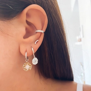 Close-up of S925 silver star and eye motif earrings with micro-set zircon details