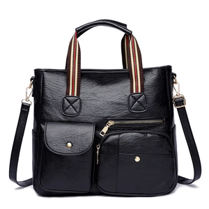 Classic black textured leather tote bag with striped handles and crossbody strap