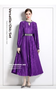 Detail of dark purple pleated dress showing crystal embellishments on the waist and neck