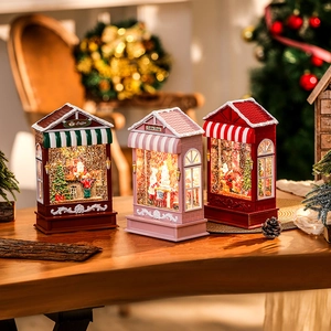 Detailed view of festive Christmas candy house snow globes with warm LED lighting effects