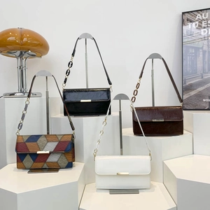 Vintage chain shoulder bags in four colors displayed on a white professional studio stand