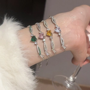 Detail of four colorful heart zircon bracelets with adjustable silver-tone chains