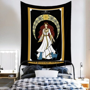 Detail of bohemian Freyja goddess tapestry with tarot motifs hanging on a bedroom wall
