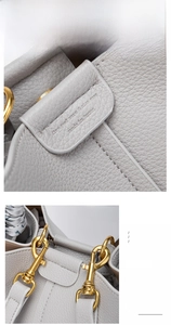 Detail of grey lychee grain leather texture and premium gold metal hook on bucket bag