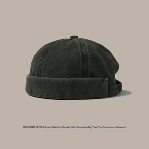 Detail of dark grey washed canvas docker hat featuring metal buckle adjustment strap
