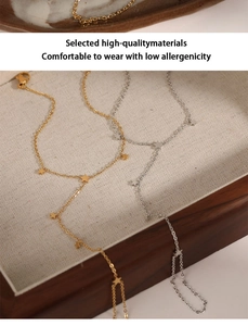 Close-up of minimalist gold and silver star charm chain bracelets on a rustic tray