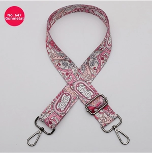 Detail of pink paisley fabric bag strap with adjustable gunmetal buckle and clasp