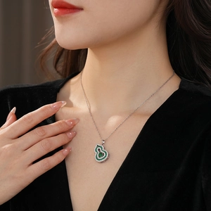 Elegant emerald green gourd necklace with white cubic zirconia in polished silver finish