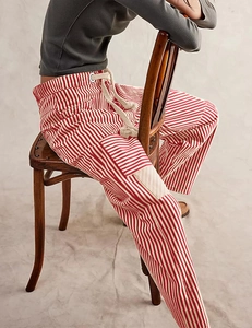 Detail of red and white striped casual pants with drawstring waist and cargo pocket style
