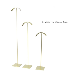 Adjustable champagne gold metal handbag display stand in three sizes on white background