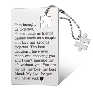 Detail of silver stainless steel wallet card and puzzle pendant with laser engraving