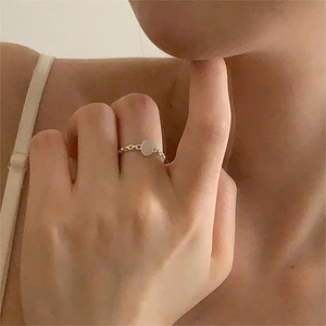 Detailed close-up of a minimalist S925 silver ring featuring an oval white gemstone