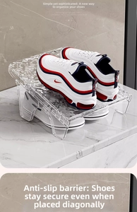 Macro detail of transparent acrylic shoe riser with non-slip baffle on marble surface