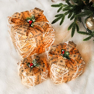 Three-piece set of illuminated Christmas gift boxes with warm LED lights and pine cone decor