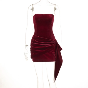 Detail view of red velvet strapless dress featuring ruched texture and elegant side ribbon