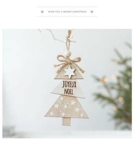 Detail of Nordic wooden Christmas tree pendant with JOYEUX NOEL text and star accents